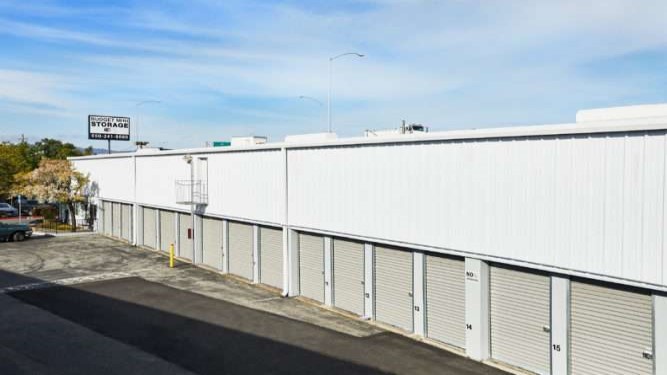 exterior row of storage units with white rollup doors