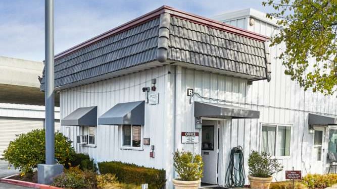 exterior of white office building with door open