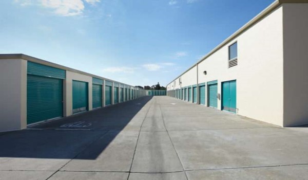 exterior aisle of storage facility with blue rollup doors