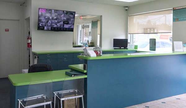 interior of storage facility office with front desk and security monitors