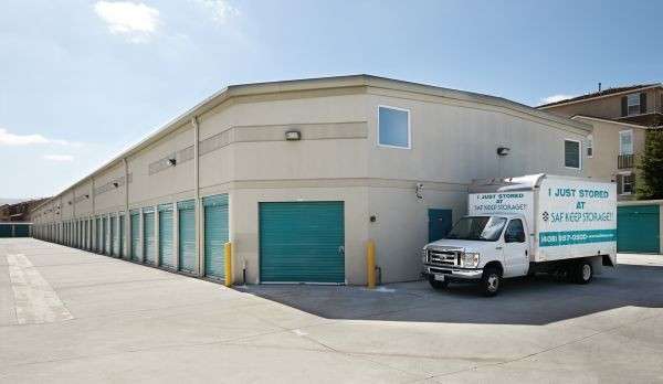 moving truck parked next to driveup storage unit doors