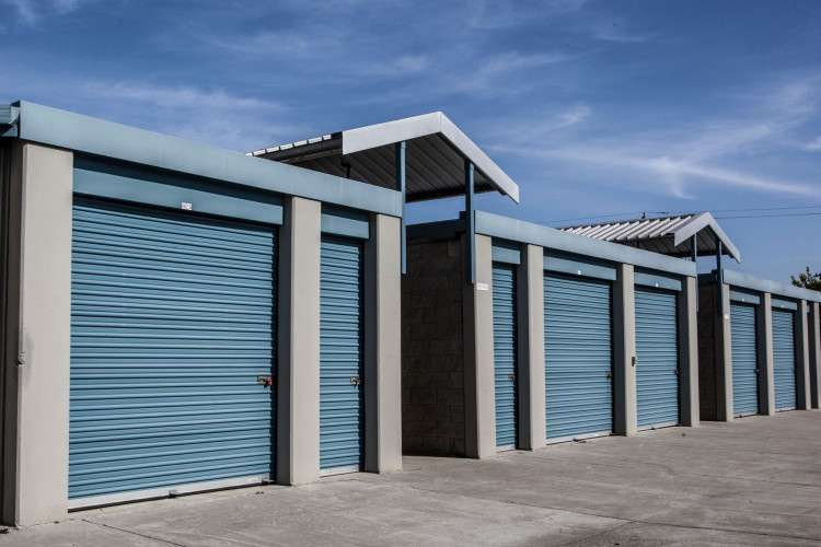 row of exterior storage unit doors of varying sizes