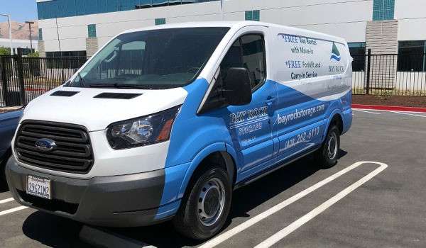 Bay Rock Storage branded moving van parked outside