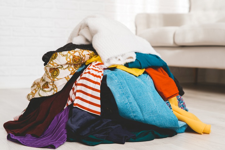  A heap of clothes in the middle of a room.