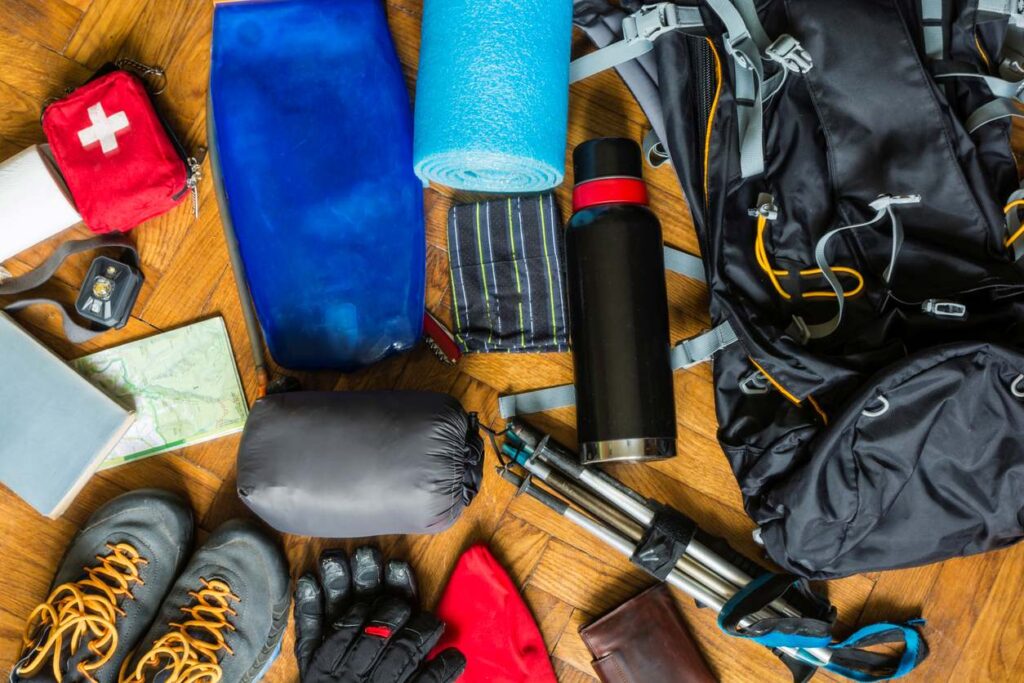 Outdoor equipment spread out on the floor.